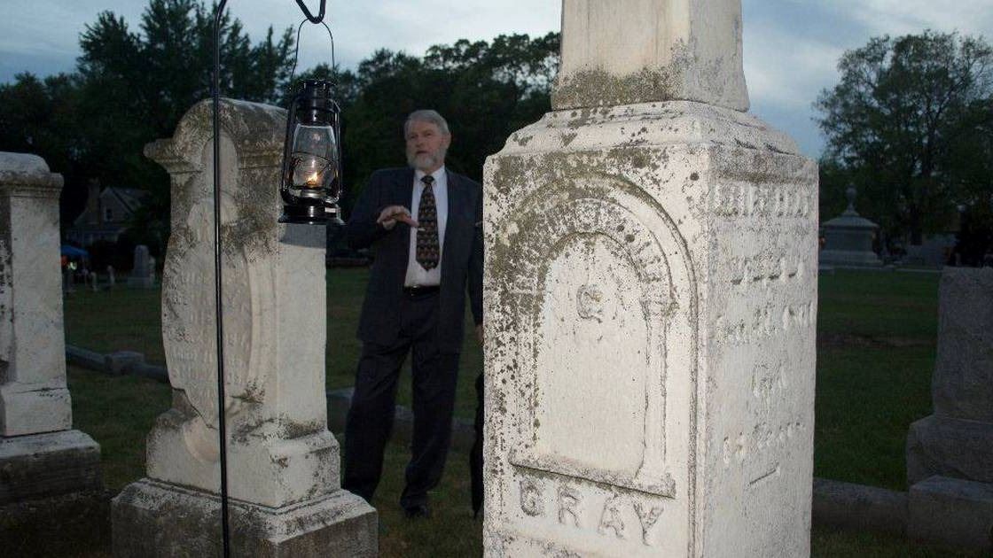 Cemetery Walk Man Presenting by Headstone